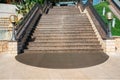 Open city stairs, under the evening sun, with escalator on the right, wide view from below Royalty Free Stock Photo