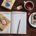 Open a clean blank Notepad, Valentines Day homemade gifts, a Cup of tea and sweets on wooden brown table. Royalty Free Stock Photo