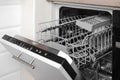 Open clean empty dishwasher in kitchen. Home appliance Royalty Free Stock Photo