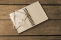 Open clean notebook and glasses on wooden table