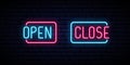 Open and Close neon iscription on brick wall background.