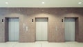 Open and closed chrome metal office building elevator doors realistic photo. Lift transportation floor to floors with push switch