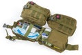 Open and closed military individual first aid kits in pouches
