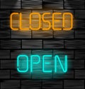 Open and closed neon inscription. Light sign on black brick wall background.