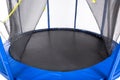 Open closeup trampoline for children and adults for fun indoor or outdoor fitness jumping on white background Royalty Free Stock Photo