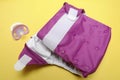 Open Cloth Diaper with Dummy on Yellow Background