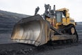 Extraction of minerals. Heavy powerful bulldozer in the quarry