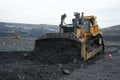 Extraction of minerals. Heavy powerful bulldozer in the quarry