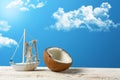 Open coconut with the model of a sailing boat and the blue sky i Royalty Free Stock Photo