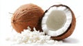 Open coconut with shredded coconut flakes spilling on white table Royalty Free Stock Photo