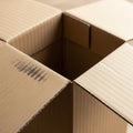 An open corrugated cardboard box with partially folded flaps, showing interior space. Royalty Free Stock Photo