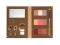 Open cosmetic set with eye shadows, makeup brushes and mirror in beige suede case