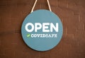 We are open with covid safety sign on shop entry