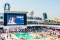 View of Open deck with a luxurious pool and numerous tourists, ship MSC Meraviglia