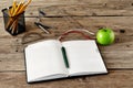 Open diary with blank pages in the workplace closeup apple and o