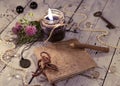 Open diary with old clock, black candle, quill and medallion on planksBlack candle with diary, medallion, key and mystic objects o