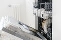 Open dishwasher with clean dishes at home kitchen Royalty Free Stock Photo