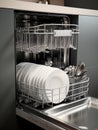 Open dishwasher with clean dishes inside. AI Royalty Free Stock Photo