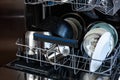 An open dishwasher with clean dishes in the kitchen. Royalty Free Stock Photo