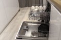 Open dishwasher with clean dishes after washing in modern scandinavian kitchen. Royalty Free Stock Photo