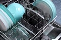 Open dishwasher with clean utensils in it,close up.Clean plates,glasses,forks,spoons after washing in the dishwasher.Dishwasher Royalty Free Stock Photo