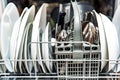 Open dishwasher with clean white plates Royalty Free Stock Photo