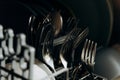 Open dishwasher close up clogged with clean washed dishes. dry cutlery closeup. spoons forks. mugs, plates. household appliances Royalty Free Stock Photo