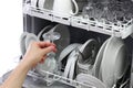 Open dishwasher, man hand taking out clean wine glass, after washing Royalty Free Stock Photo