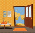 Open door into autumn view with yellow trees. Autumn interior with a coffee table, vases, pumpkins, door mat, orange wallpaper.