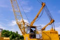 Open door on cabin of mobile crane truck with long grated beam at the construction site Royalty Free Stock Photo