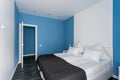Open door. daylight morning. Hotel standart room. modern bedroom with white pillows. simple and stylish interior.