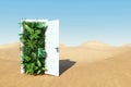 Open door in desert leading to tropical garden, green nature on desert background. Concept ecological crisis, teleport, fresh air Royalty Free Stock Photo