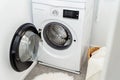 Open door of front load washing machine in laundry room. Royalty Free Stock Photo