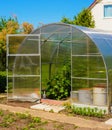 Open door of greenhouse from transparent polycarbonate