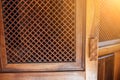 open door with lattice to wooden confessional booth for confession inside Catholic Cathedral Church close up Royalty Free Stock Photo