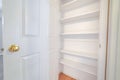 Open door showing interior empty white shelves Royalty Free Stock Photo