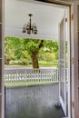 Open door to the front porch with view of the park.