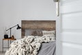 Open door to grey elegant bedroom interior with rustic design, copy space on empty wall Royalty Free Stock Photo