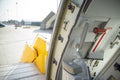 Open door to a large airliner as seen from inside. Aircraft door frame, door handle and door barrier strap