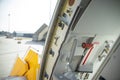 Open door to a large airliner as seen from inside. Aircraft door frame, door handle and door barrier strap Royalty Free Stock Photo