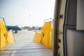 Open door to a large airliner as seen from inside. Aircraft door frame, door handle and door barrier strap