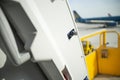 Open door to a large airliner as seen from inside. Aircraft door frame, door handle and door barrier strap Royalty Free Stock Photo