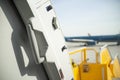 Open door to a large airliner as seen from inside. Aircraft door frame, door handle and door barrier strap Royalty Free Stock Photo