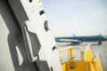 Open door to a large airliner as seen from inside. Aircraft door frame, door handle and door barrier strap