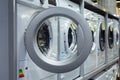 Open door of a washing machine in a household appliance store.