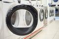 Open door of a washing machine in a household appliance store. Royalty Free Stock Photo