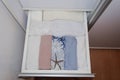 Open drawer with clear and tidy clothes. Harmony at home