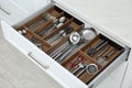 Open drawer with different utensils and cutlery in kitchen, above view Royalty Free Stock Photo