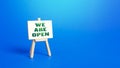 We Are Open easel sign. Exit from severe quarantine conditions, economic and business recovery. Return to normal life. Adaptation