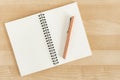 An open eco-friendly carton recycled notebook with a pencil on a wooden office desk mockup Royalty Free Stock Photo